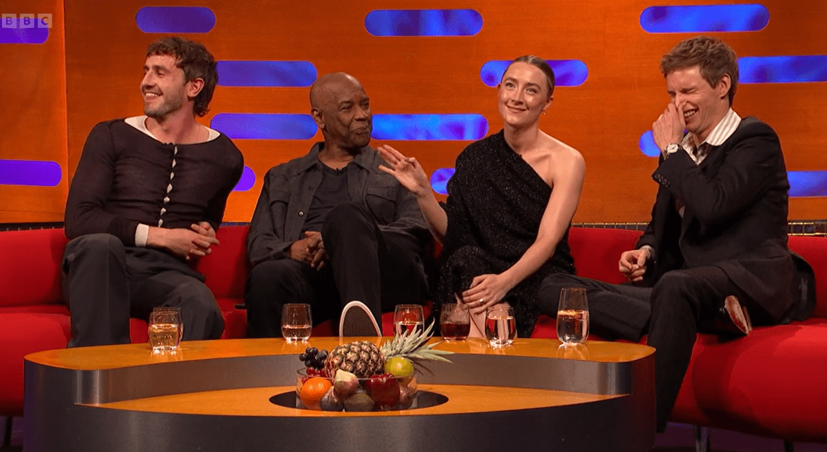 a group of people sitting around a table with bbc written on the bottom