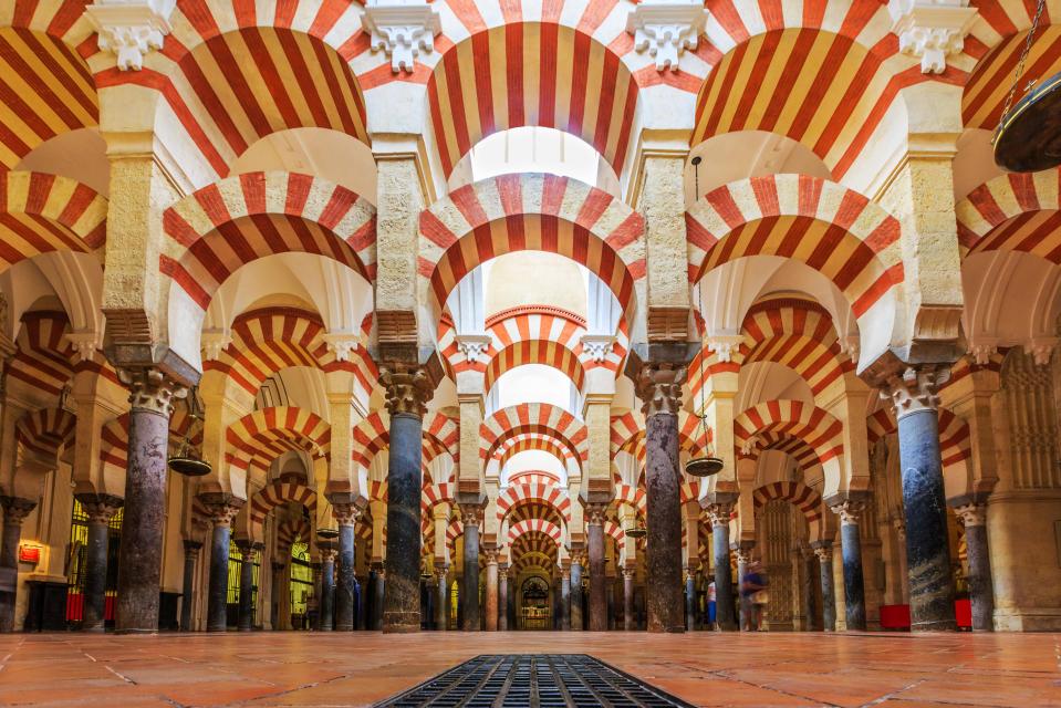 the inside of a building with arches and columns