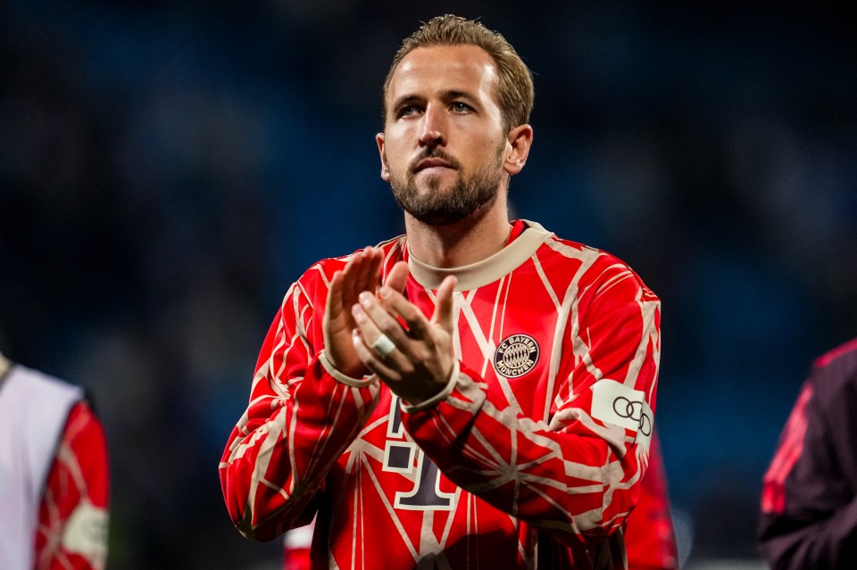 a soccer player wearing a red jersey with the number 1 on it