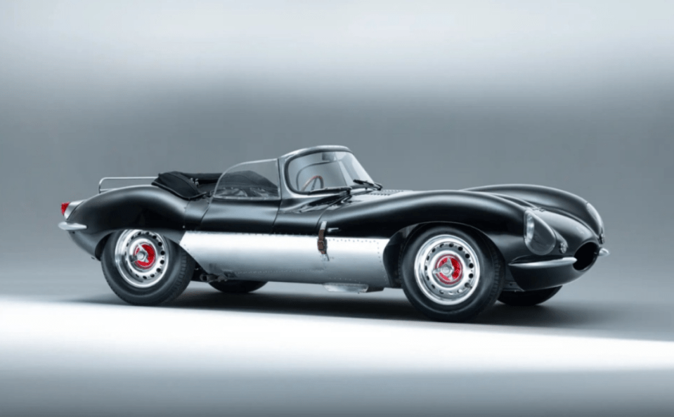 a black and silver sports car with red wheels