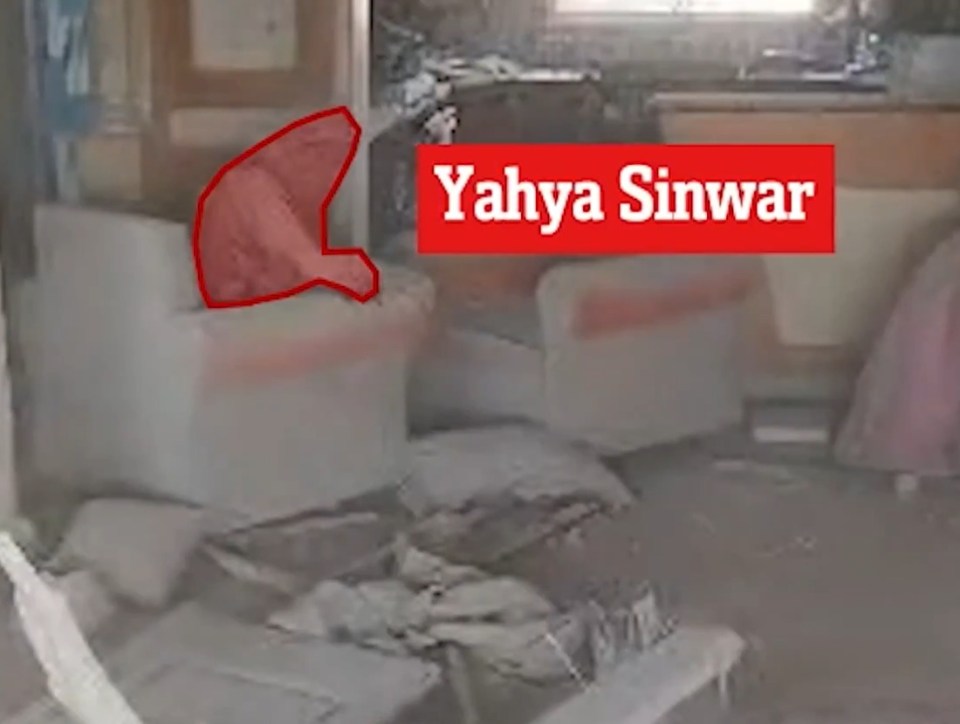 a living room with a red sign that says yahya sinwar