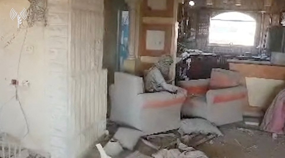 a man is sitting on a couch in an abandoned room .