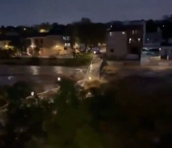 a car is stuck in a flooded street at night