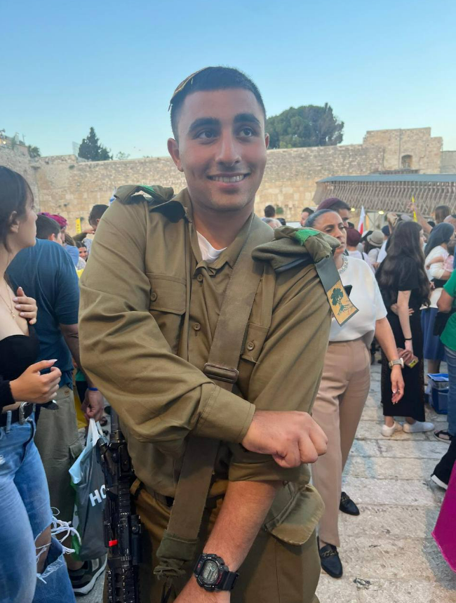 a man in a military uniform has the word hc on his sleeve