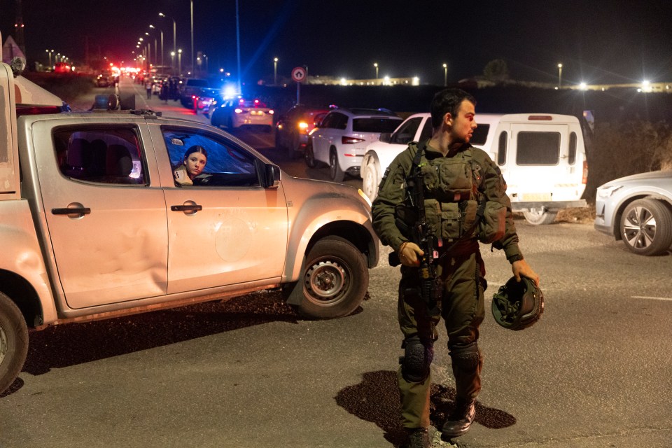a man in a military uniform stands in front of a white truck