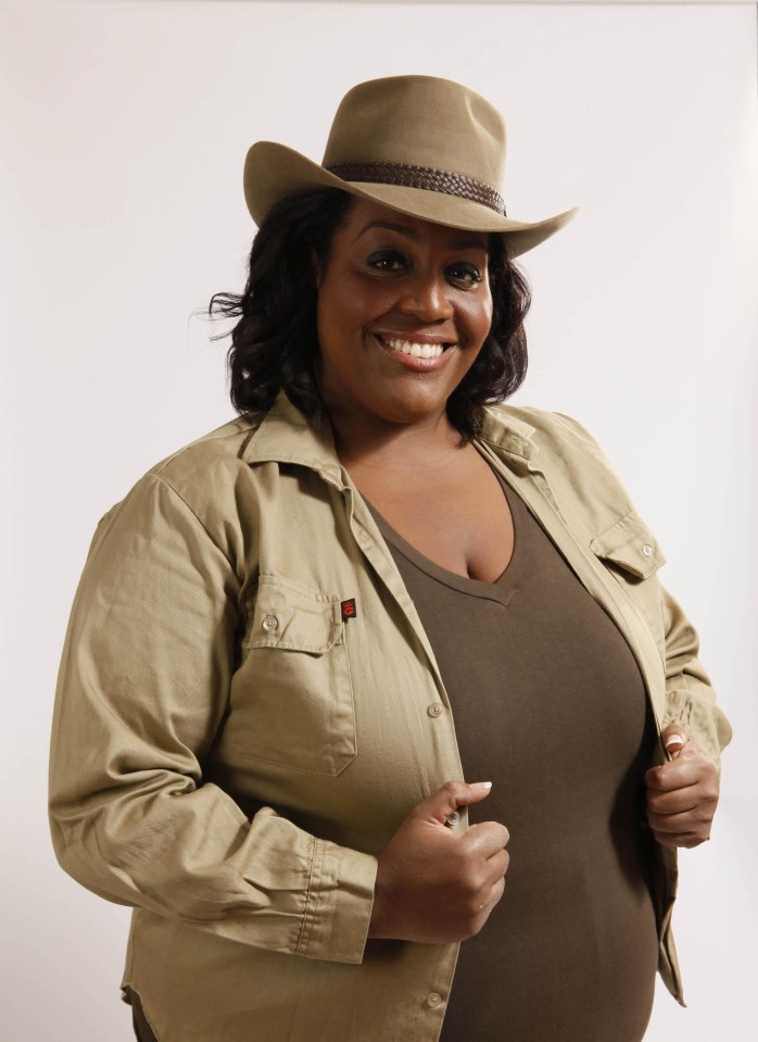 a woman wearing a cowboy hat and a tan shirt