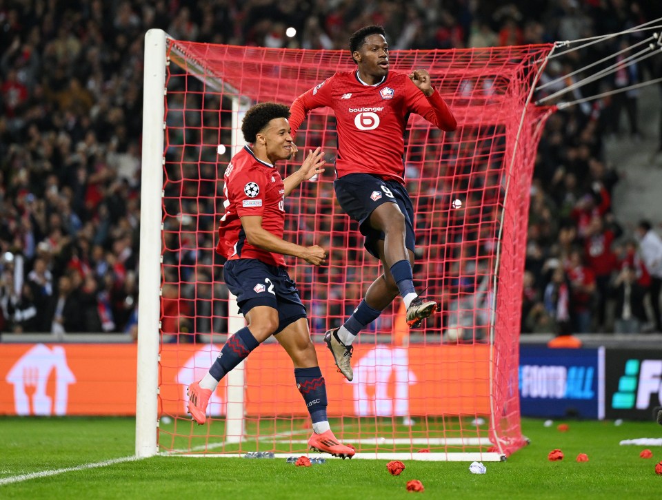 two soccer players are jumping in the air while wearing new balance jerseys