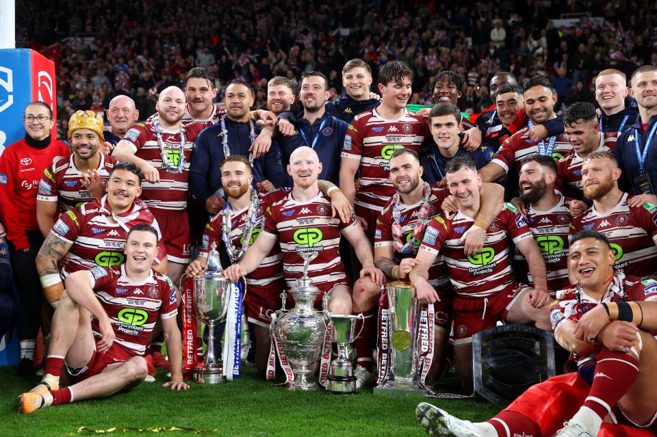 a group of rugby players are posing for a picture with a trophy that says ' gp ' on it