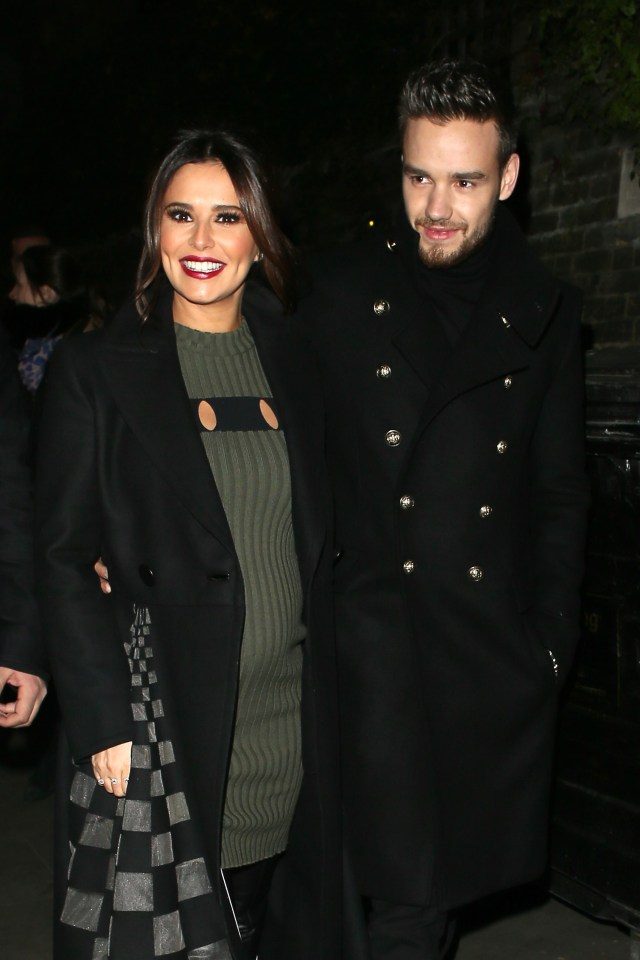 a man and a woman are posing for a picture and the woman is smiling