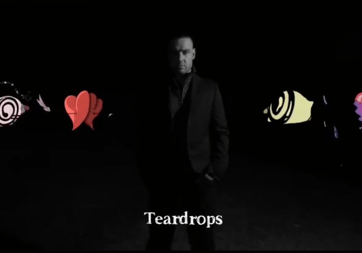 a man in a suit stands in the dark with the words teardrops below him