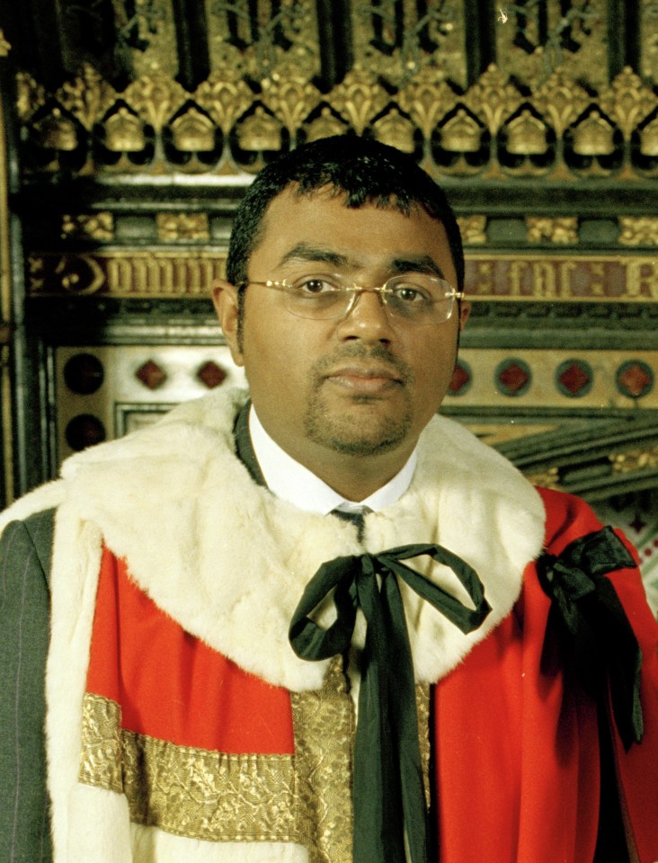 a man in a robe with the letter r on it