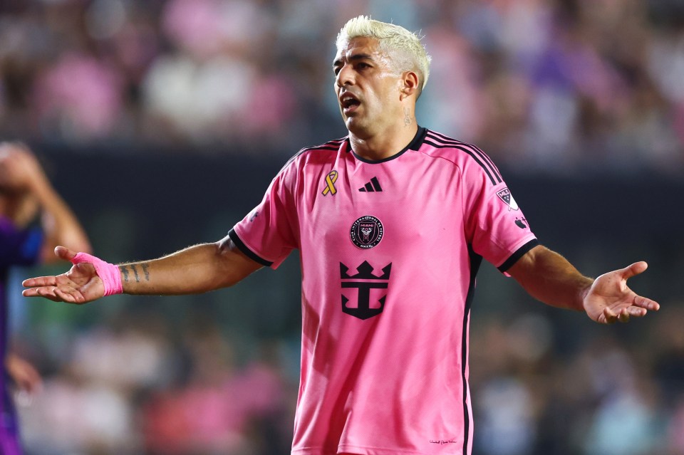 a soccer player wearing a pink shirt with a crown on it