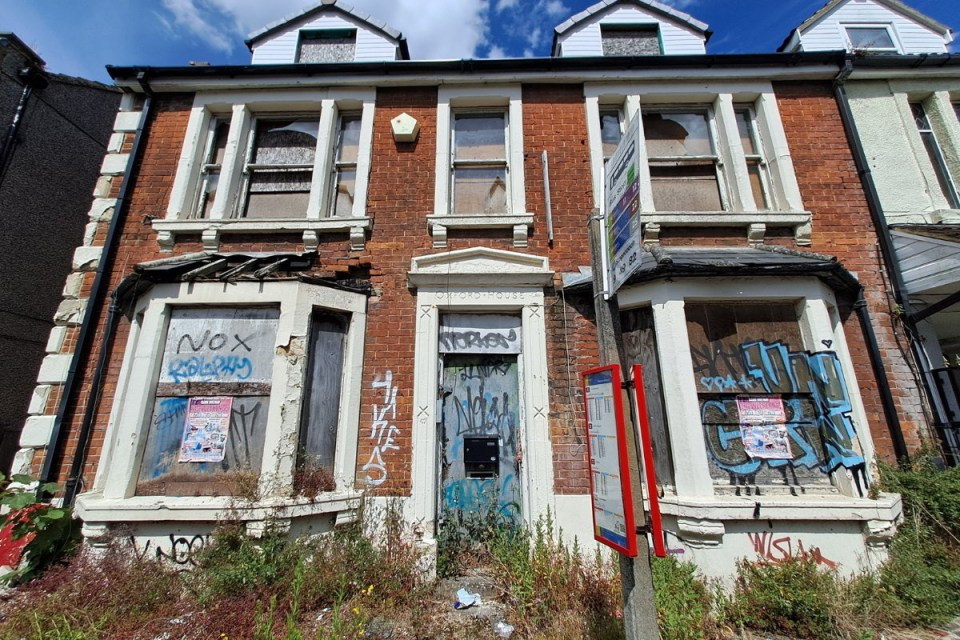 a brick building with graffiti on it including the word nox