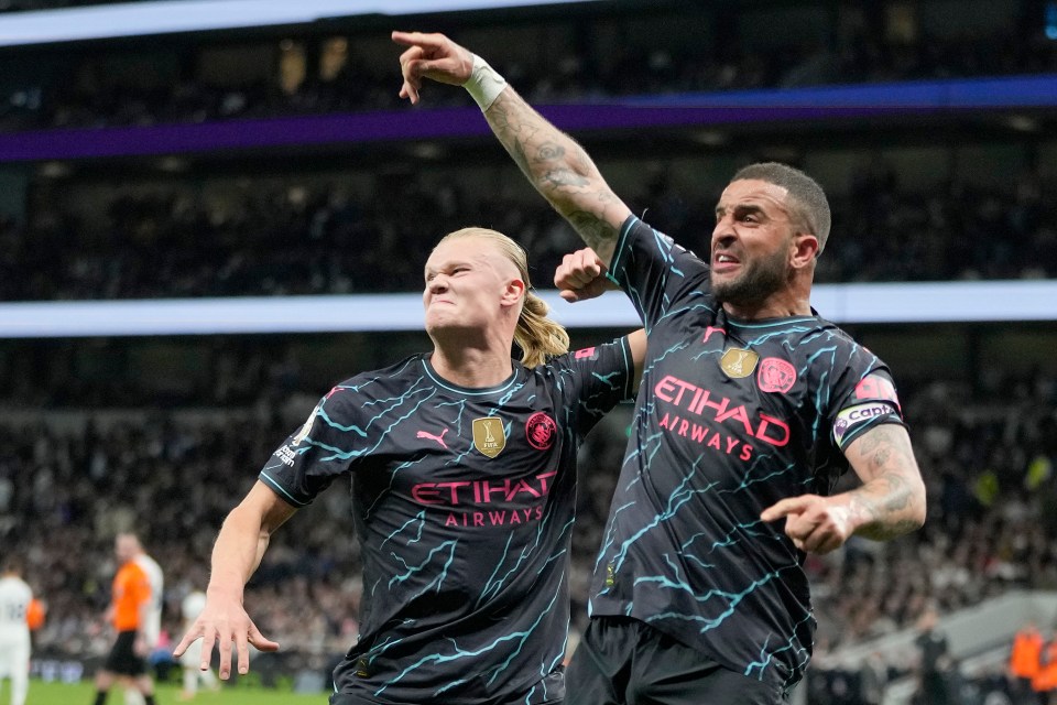 two soccer players wearing etihad airways jerseys celebrate