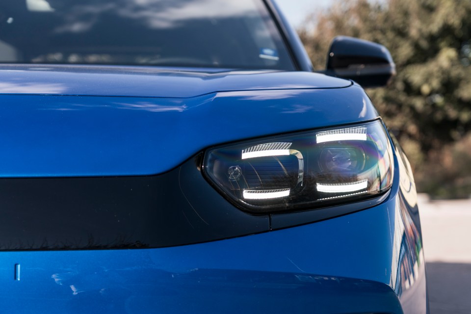 a close up of the headlight of a blue car