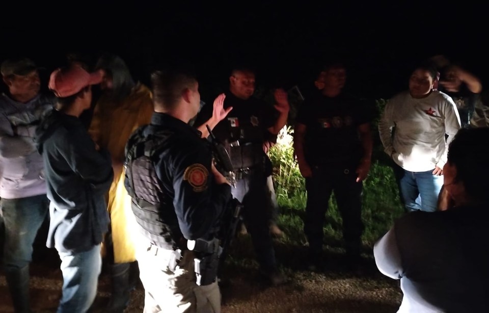 a group of people are standing around a police officer