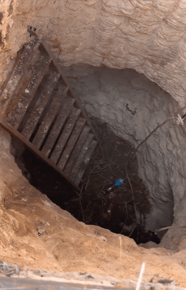 a staircase leading up to a hole in the ground