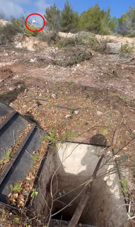 a hole in the ground with trees in the background