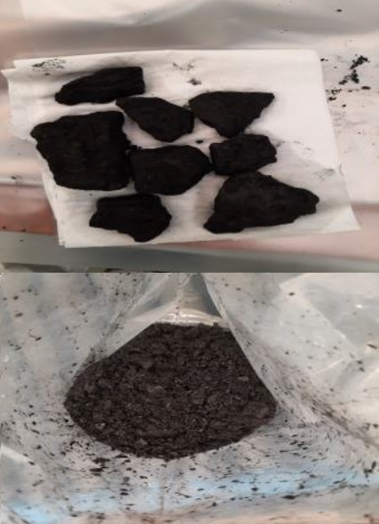 a pile of rocks sitting on top of a piece of paper next to a bag of rocks .