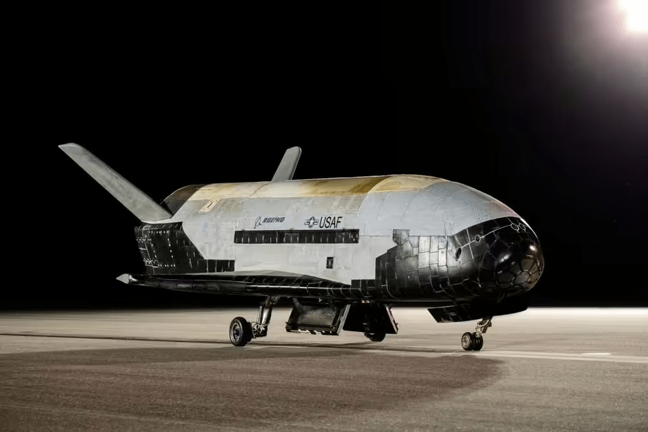 a boeing space shuttle sits on a runway at night