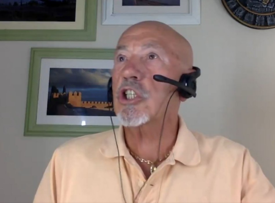 a man wearing a headset with a picture of a castle in the background
