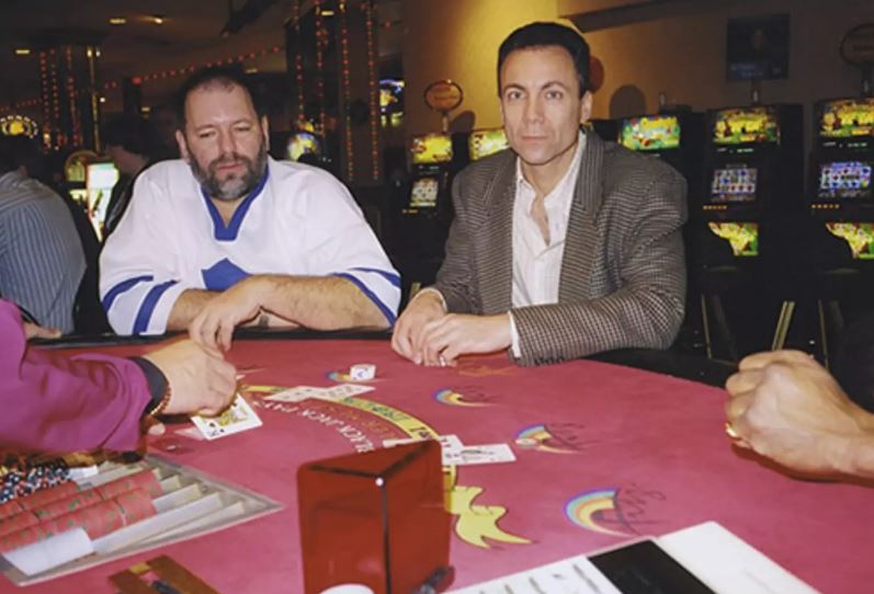 a group of men are playing blackjack at a table