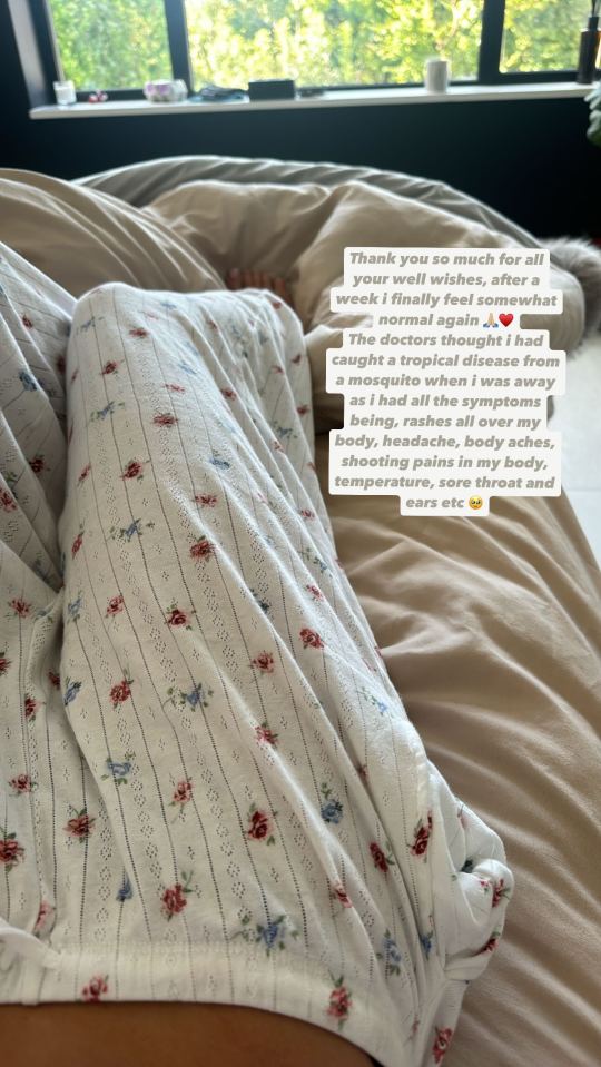 a person laying on a bed with a floral shirt on