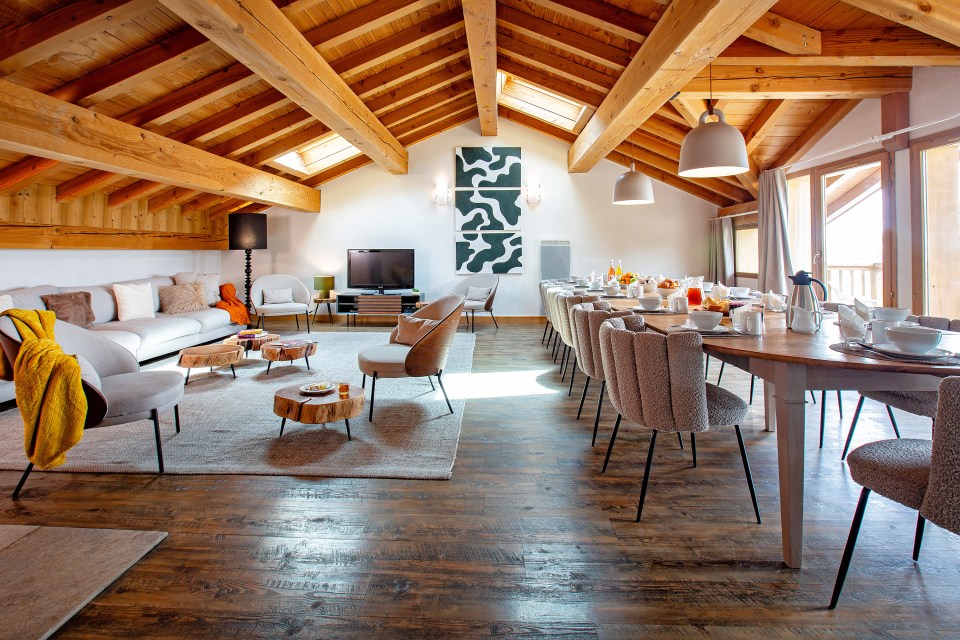 a living room with a table and chairs and a tv