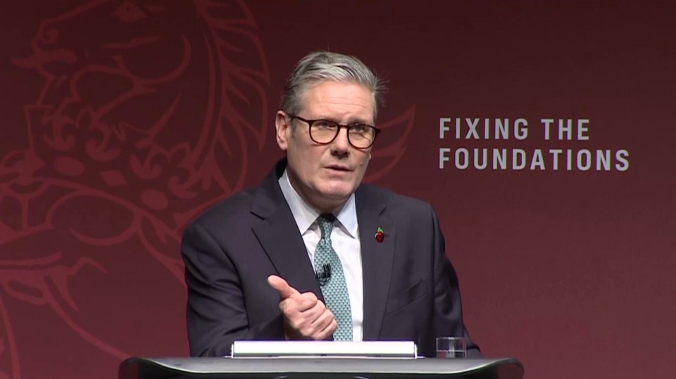 a man stands at a podium with the words fixing the foundations behind him
