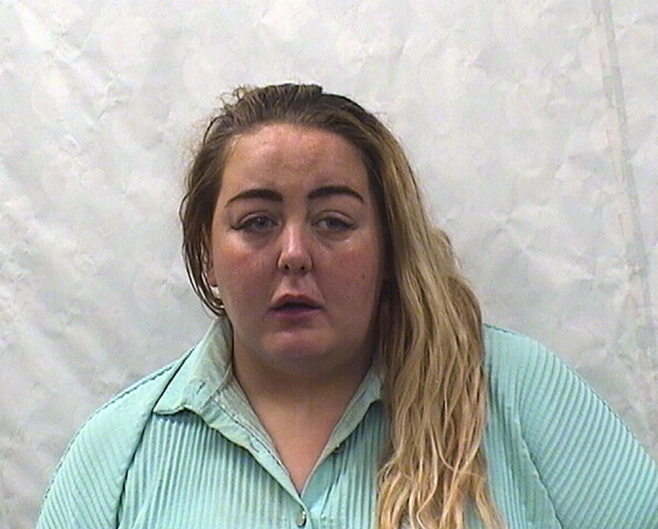 a woman with long blonde hair is wearing a blue shirt