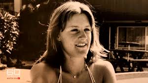 a woman in a bikini is smiling in a black and white photo .