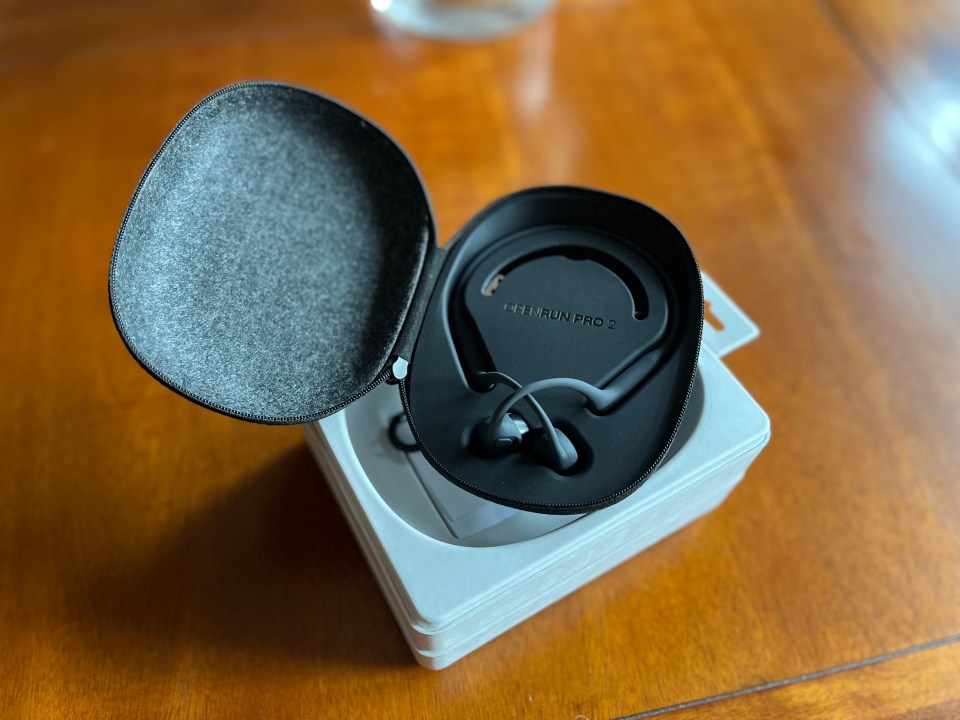 A pair of Shokz OpenRun Pro 2 headphones in their case