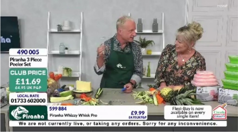 a man and a woman are sitting at a table with vegetables .