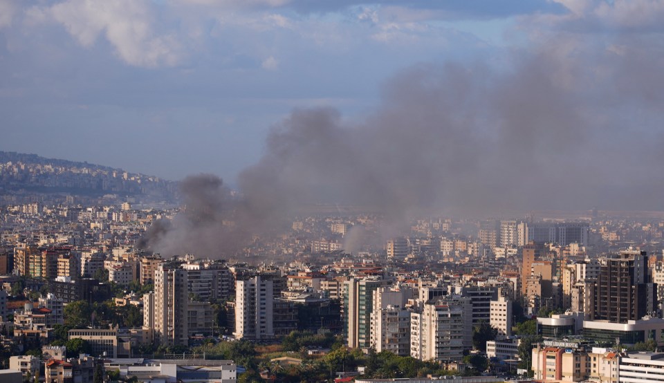 smoke is coming out of a building in a city