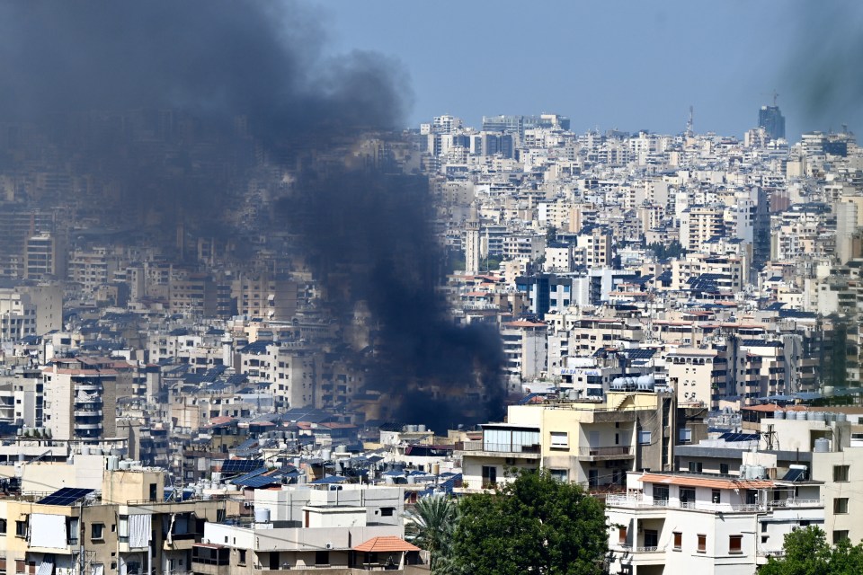 smoke is coming out of a building in a city