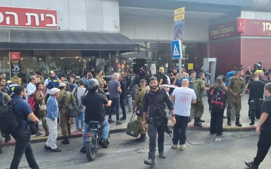 a group of people are standing in front of a store that says בית הדין