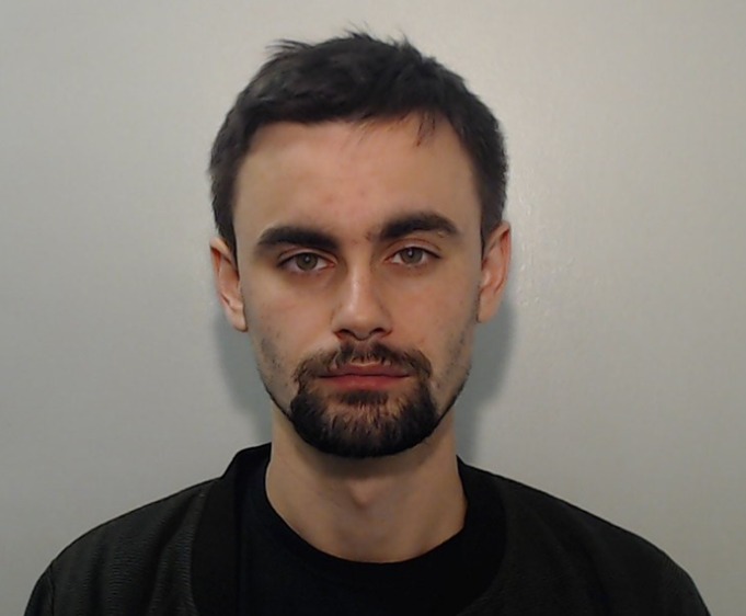 a man with a beard is wearing a black shirt