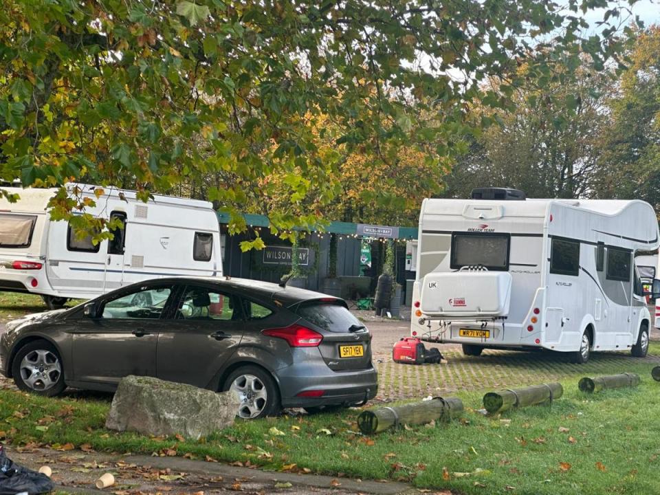 a ford focus is parked in front of a caravan that says uk on the back