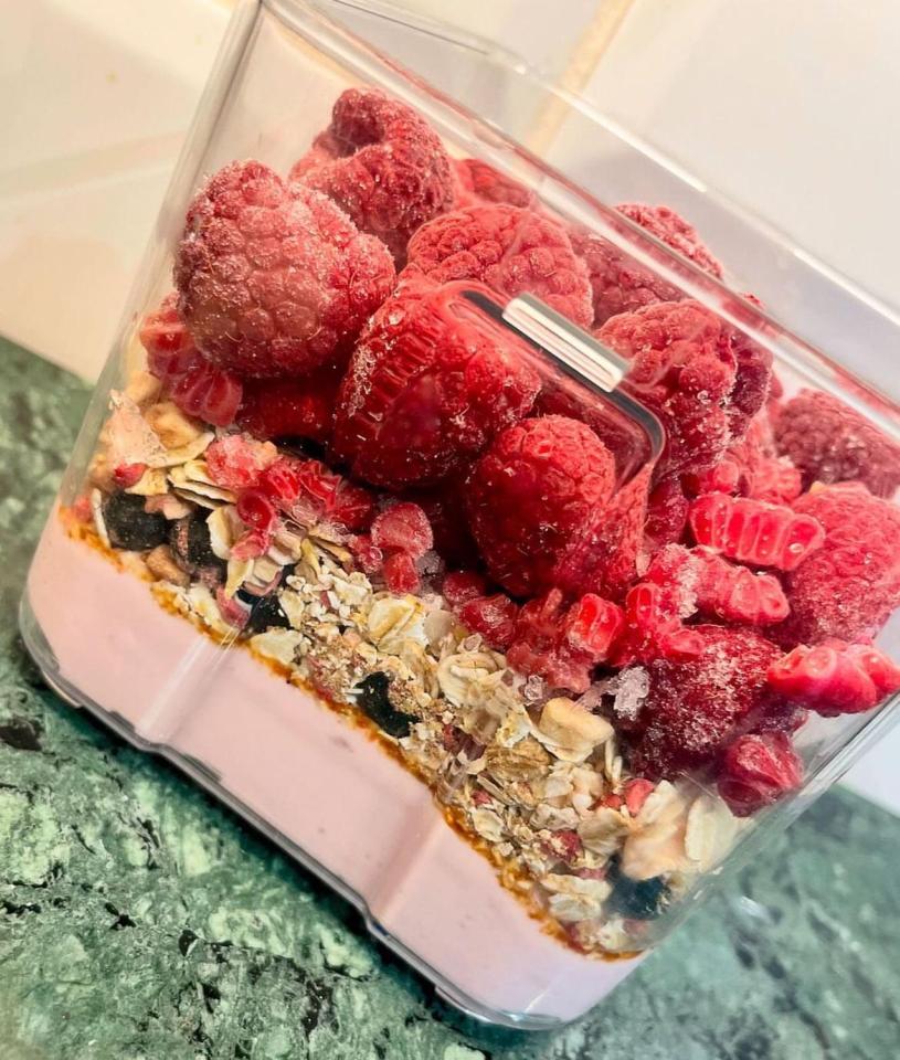 a blender filled with raspberries oats and other ingredients