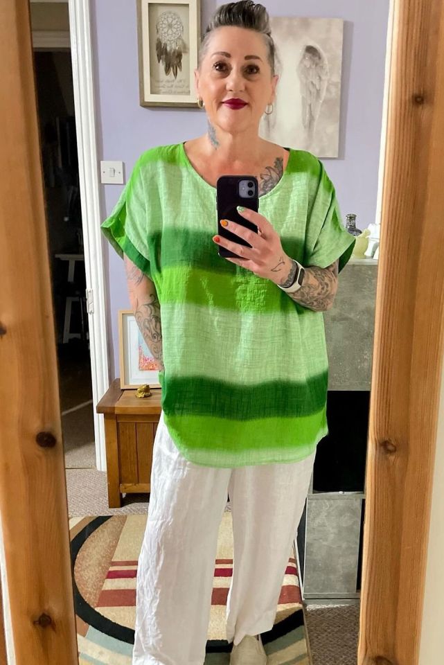 a woman taking a picture of herself in a mirror