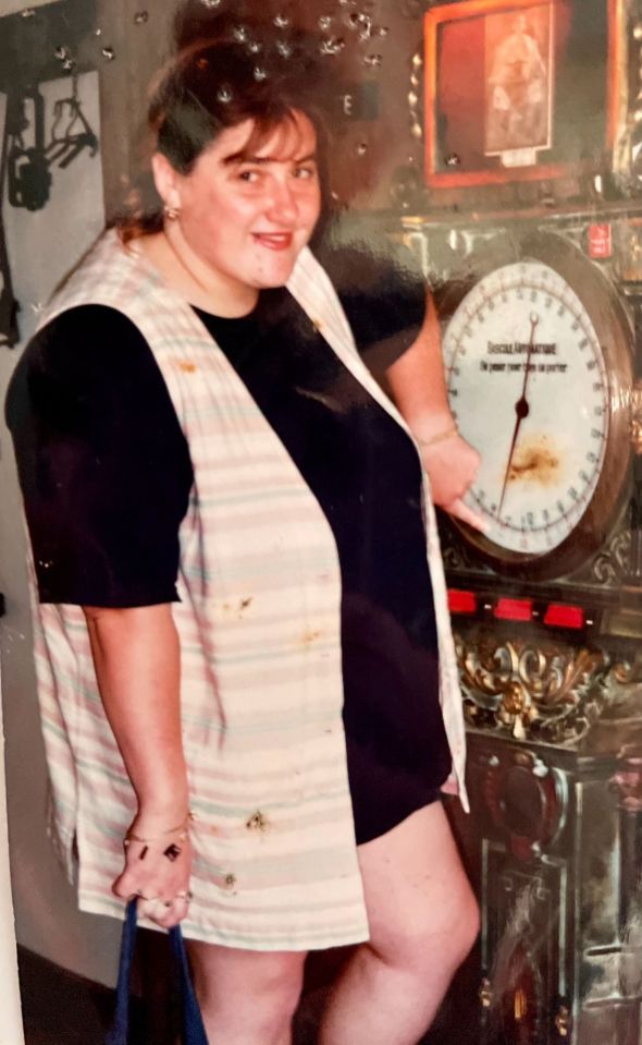 a woman is standing in front of a clock that says ' social entertainment ' on it