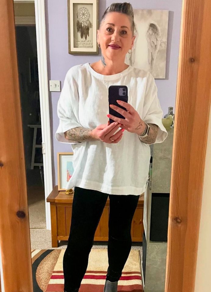 a woman taking a selfie in front of a mirror