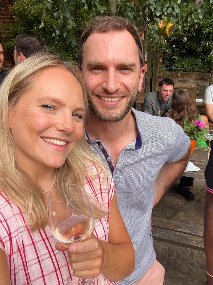a woman holds a glass of wine next to a man
