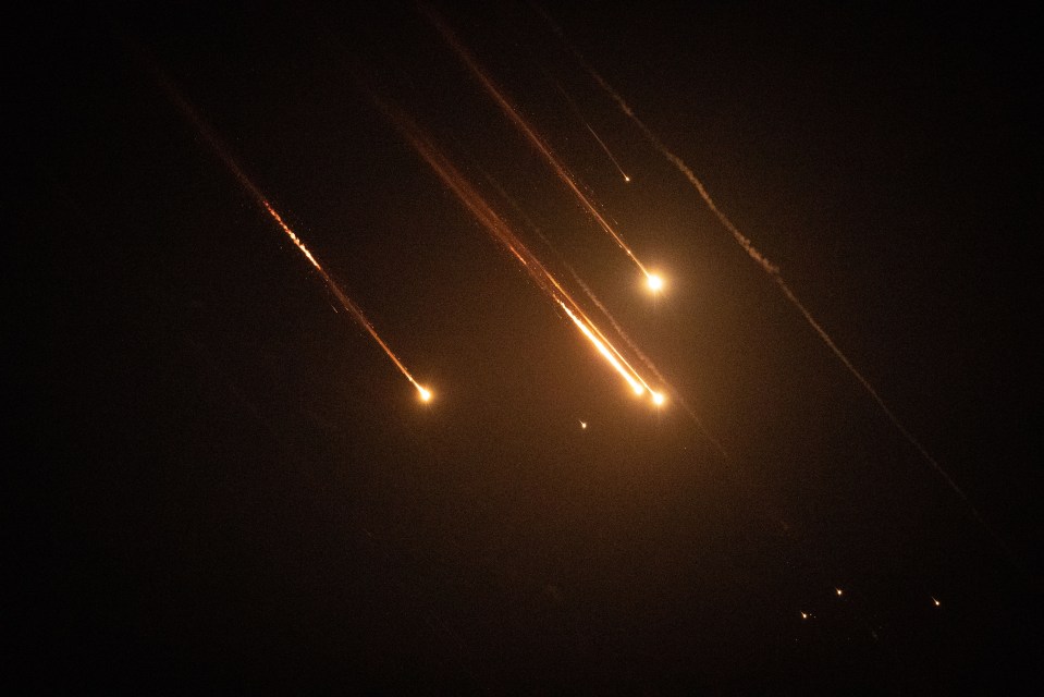 a dark sky with a few lines of light coming out of it