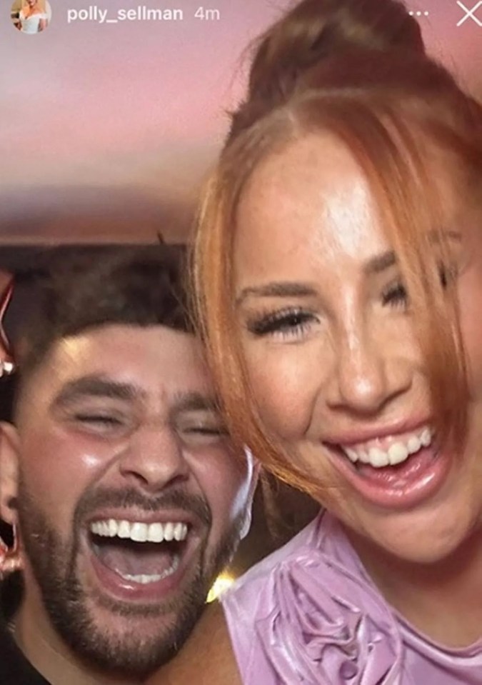 a man with a beard and a woman with red hair smile for a photo