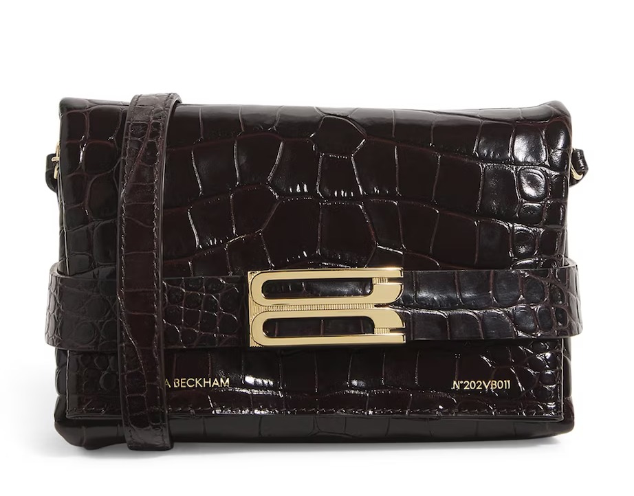 a brown beckham purse with a gold buckle