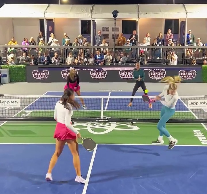 two women are playing tennis on a court that has a sign that says ' lapplasty ' on it
