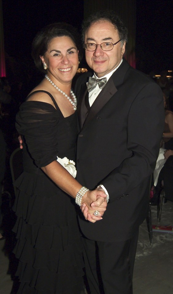a man and a woman are holding hands and smiling