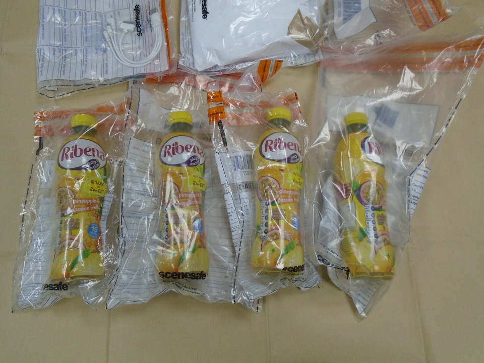 four bottles of ribena orange juice are wrapped in plastic