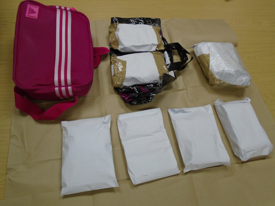 a pink adidas bag sits next to a bunch of packages